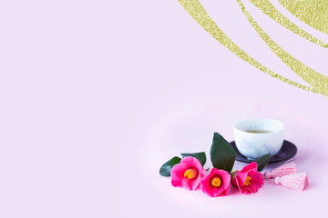 お正月　椿の花束と緑茶とピンクのタッセルと金色の波模様の合成画像（ピンクバック）
