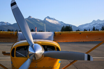 Yellow bush plane, workhorse of the great northern wilderness.  Three bladed propeller powers the stout and reliable high wing aircraft. Remote and isolated communities rely on air travel