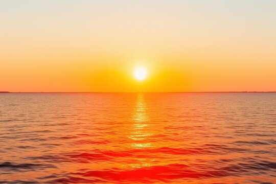 An image of a vibrant sunset casting a golden glow over a tranquil seascape, painting the sky in hues of gold, orange, and pin