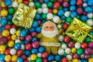Christmas and New Year decoration with Santa Claus and gift box on colorful ball background.