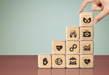 Employee benefits, hand hold wooden cubes