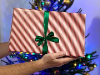 A man holds a gift in his hands.