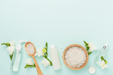 Flat lay with spa products and flowers on color background