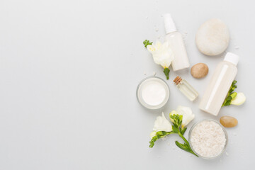 Flat lay with spa products and flowers on color background