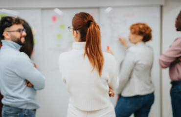 Colleagues brainstorming, collaborating, and discussing strategies for business expansion and profit growth in a successful corporate office setting.
