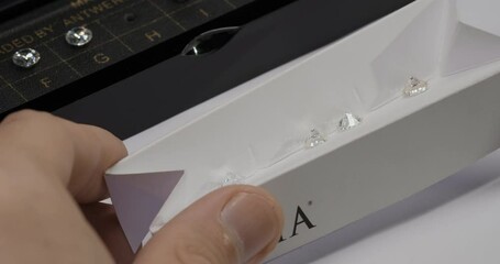 Specialist checks diamond quality. Diamond color grading with master stones. Gemstone laboratory. Diamond or gem grading and valuation. Close-up