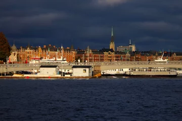 Foto auf Glas cityscape of Stockholm with dark clouds © johannes81