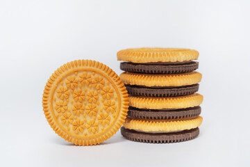 chocolate and milk round cookies on a white background. sandwich of two types of cookies on a light...