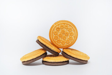 chocolate and milk round cookies on a white background. sandwich of two types of cookies on a light background. a subject photo session of sweet cookies in a photo studio