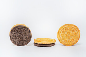 chocolate and milk round cookies on a white background. sandwich of two types of cookies on a light...