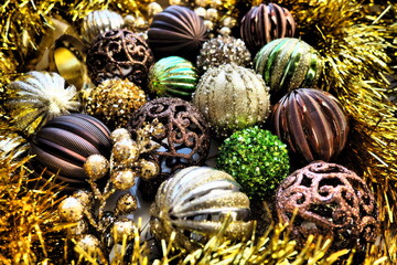 New Year's Christmas balls, tinsel and decorations close up. A lot of decoration of golden, brown,...