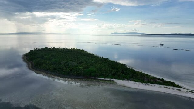 Early morning light illuminates the remote island of Koon near Seram, Indonesia. This scenic island's coral reefs, and the surrounding seas, support extraordinary marine biodiversity.