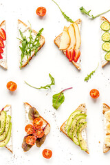 lunch with triangle sandwiches on white table background top view