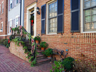 Brick steps leading to the front door with Christmas decorations.