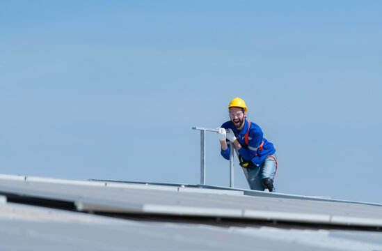 A new technician trainee working on solar panels with a fear of heights