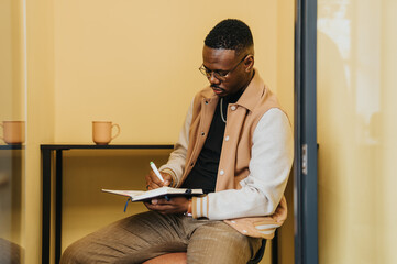 Black business employee working and discussing project details in the workplace.