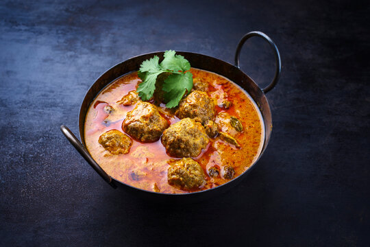 Traditional spicy Indian meat balls curry Rogan Josh with ground beef and rice served as close-up in a Nordic design bowl