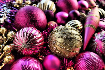 New Year's Christmas balls, tinsel and decorations close up. Decorations of golden, pink, lilac,...