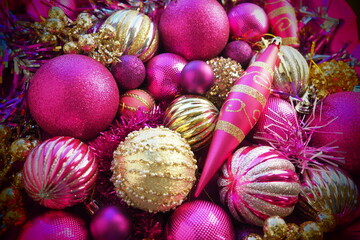 New Year's Christmas balls, tinsel and decorations close up. Decorations of golden, pink, lilac,...