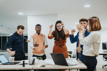 Multiethnic colleagues in a creative office collaborate on project coordination, profitability, and...