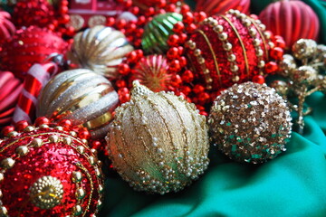 New Year's Christmas balls, tinsel and decorations close up. A lot of decoration of golden, red,...