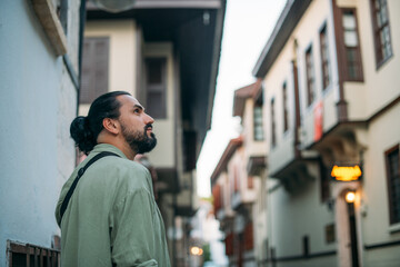 Portrait of a male tourist on a picturesque street of the old town.