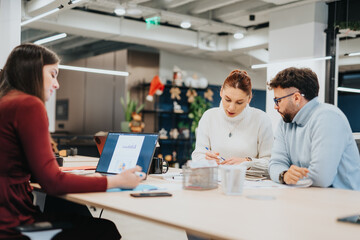 Diverse group strategizing for business expansion, discussing market analysis and financial planning for profit growth.