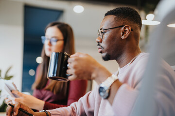 Diverse professionals discuss market analysis, strategize for business growth in a corporate office. Successful teamwork and technology drive sales.