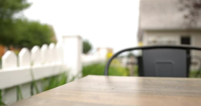 Man picking up and drinking beer at outdoor patio - close up on fresh beer glass