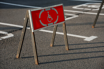 A road sign in the parking lot for the disabled