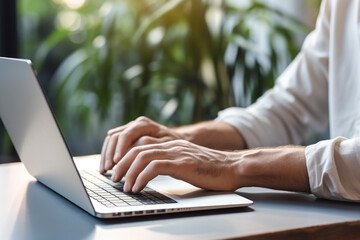 close up of hands typing on laptop