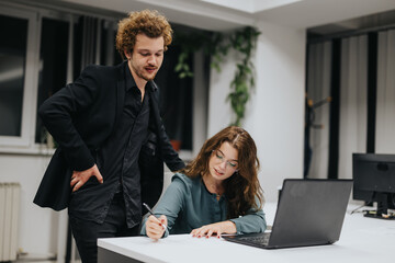 In an office, a couple collaborates on financial planning, market analysis, and profit growth. Young business people persistently strategize for competitive analysis and revenue growth.