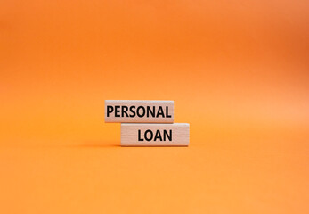 Personal Loan symbol. Concept word Personal Loan on wooden blocks. Beautiful orange background....