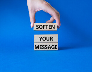Soften your Message symbol. Concept words Soften your Message on wooden blocks. Beautiful blue background. Businessman hand. Business concept. Copy space.
