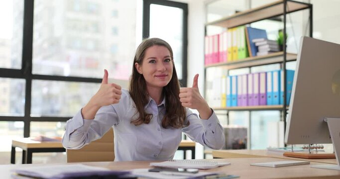 Businesswoman manager showing thumb up at desk in office 4k movie slow motion