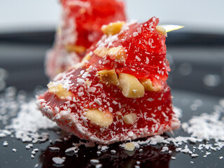 Turkish delight. Red Lokum with nuts and coconut flakes