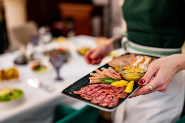 waiter holds tray with food. Restaurant service. buffet or catering.