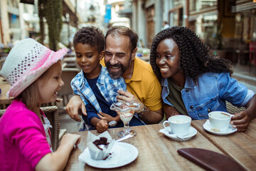 Multicultural Family Enjoying Desserts at an Outdoor Cafe