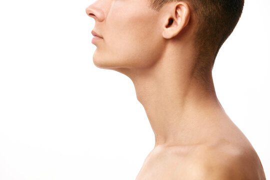 Cropped image of young man's face with neck against white studio background. Face shape correction, double chin. Concept of male beauty, skin care, spa, cosmetology, men's health
