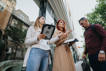 Young entrepreneurs collaborate in the city, discussing business opportunities and brainstorming...