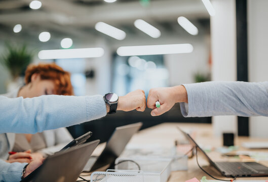 Fist bump concept. Colleagues giving fist bump. Bumping fists. Teamwork concept. Success concept. Coworkers giving fist bump. Respect concept.