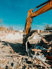 Large yellow industrial construction excavator or bulldozer equipment working at a demolition site....