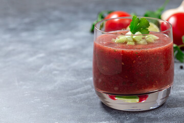Cold soup Gazpacho served in glass garnished with cucumber and cilantro, horizontal, copy space