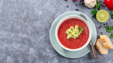 Soup Gazpacho garnished with cucumber and cilantro, in bowl, horizontal top view, copy space