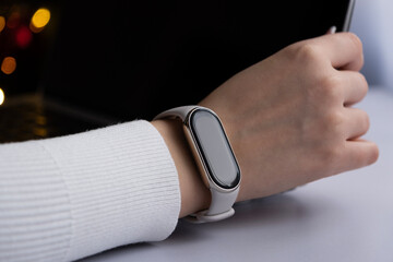 Female hand using laptop with smart watches on a wrist