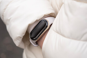 Woman's hand in a pocket with smart watches on a wrist