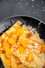 crepe sweet pancake orange fruit syrup fresh dessert eating cooking appetizer meal food snack on the table copy space food background rustic top view