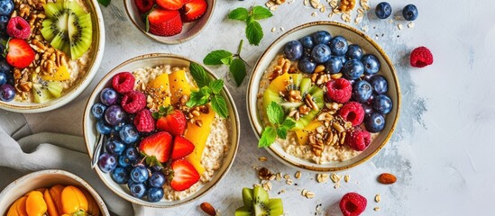 Healthy breakfast or snack with spelt porridge, fruits, berries, and nut topping on a bright background.