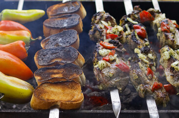 BBQ food party summer grilling meat in the afternoon of weekend happy party close-up. Kebabs with vegetables are cooked on a charcoal barbecue grill. Selective focus. 