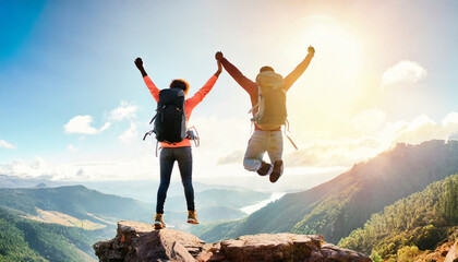 Euphoric young hikers triumphantly leap atop a mountain, celebrating their adventurous journey with arms raised and backpacks on